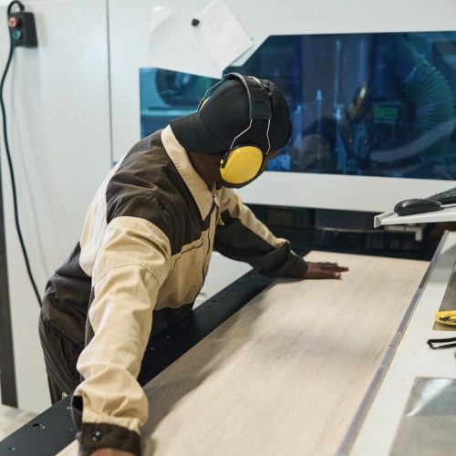 worker-working-machine-sawing-wood_274679-35851